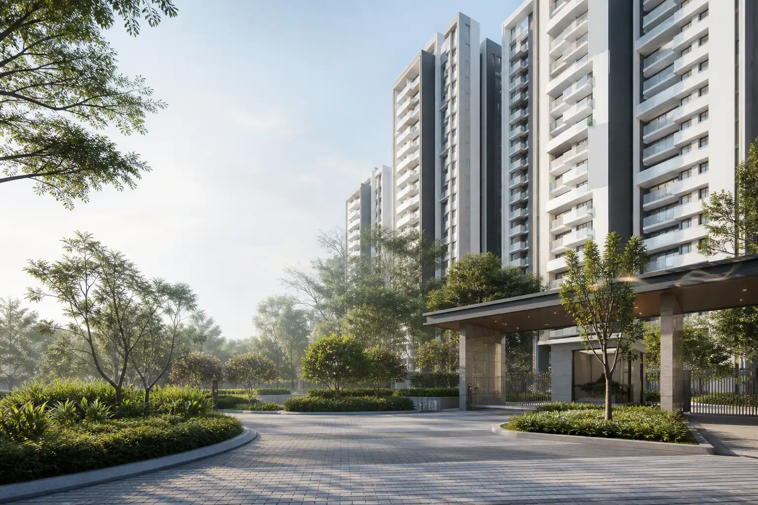 Contemporary white and charcoal apartment towers beside a landscaped arrival court