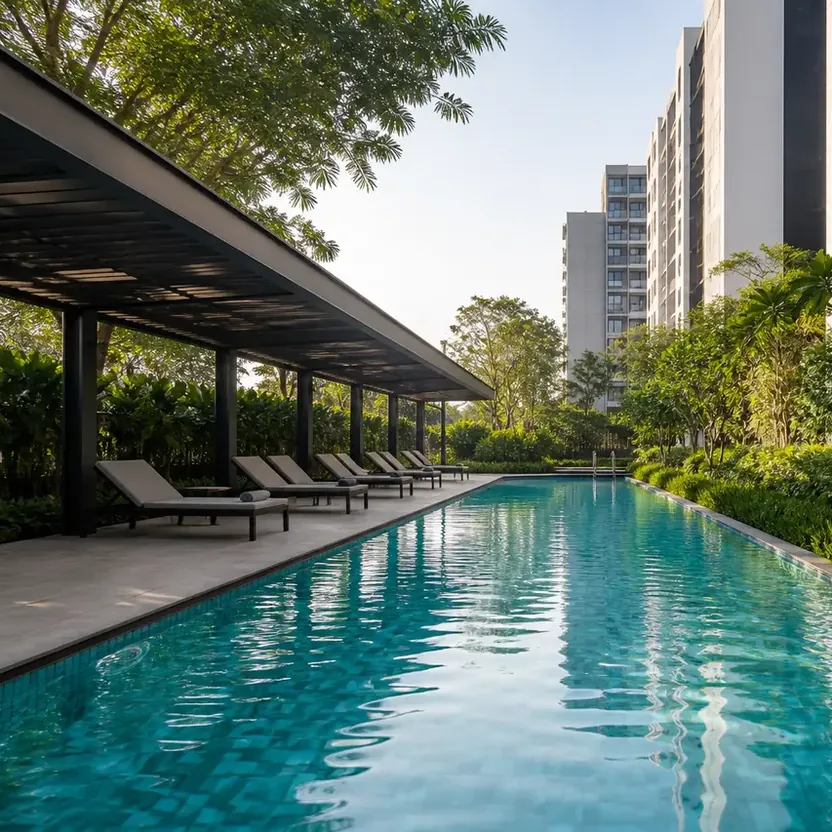 Modern Spaaces Chikkadunnasandra, artistic impression A pool deck with loungers under a pergola beside the towers